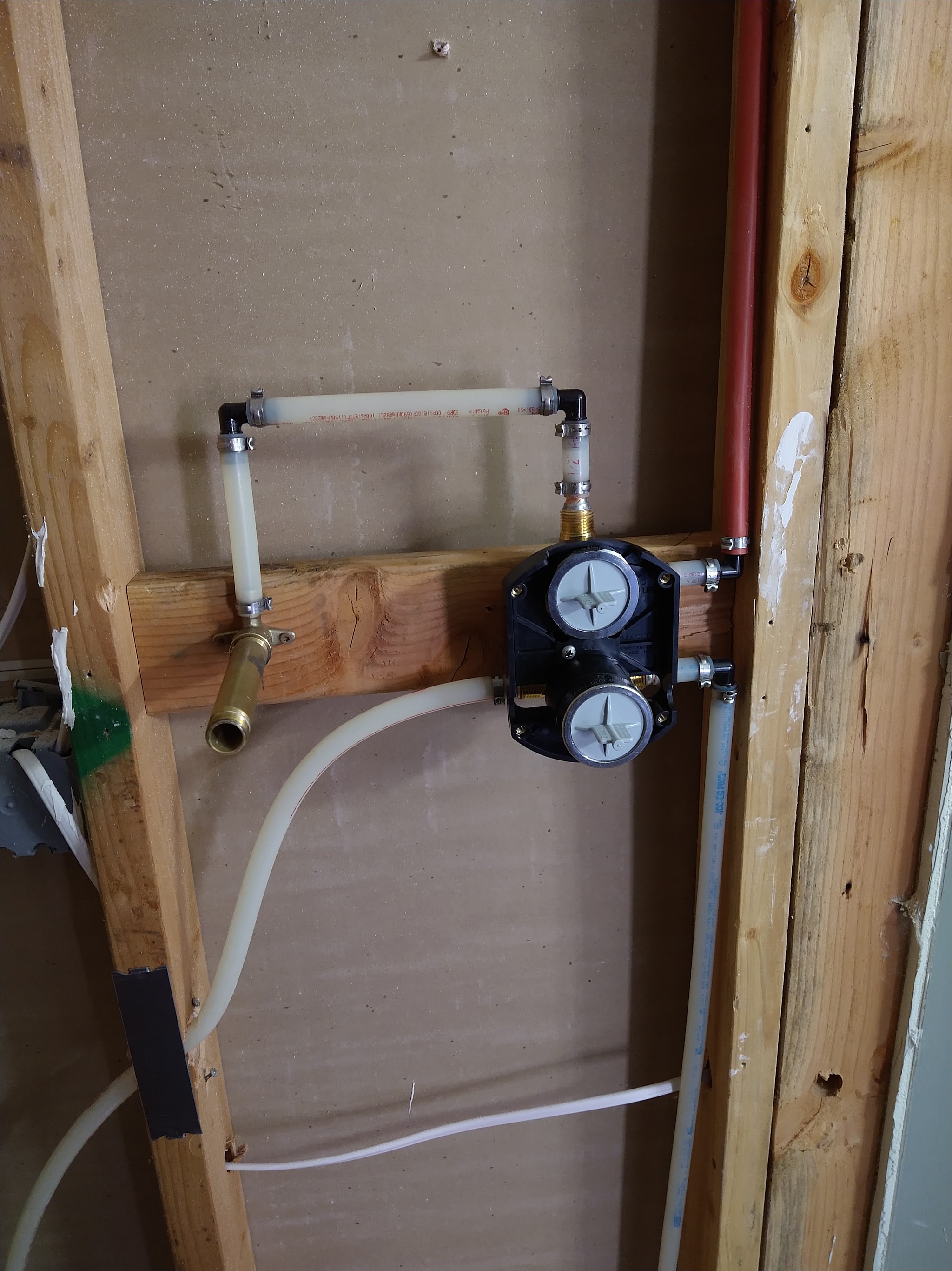 Shower valve and PEX rough-in plumbing installed in an open stud wall