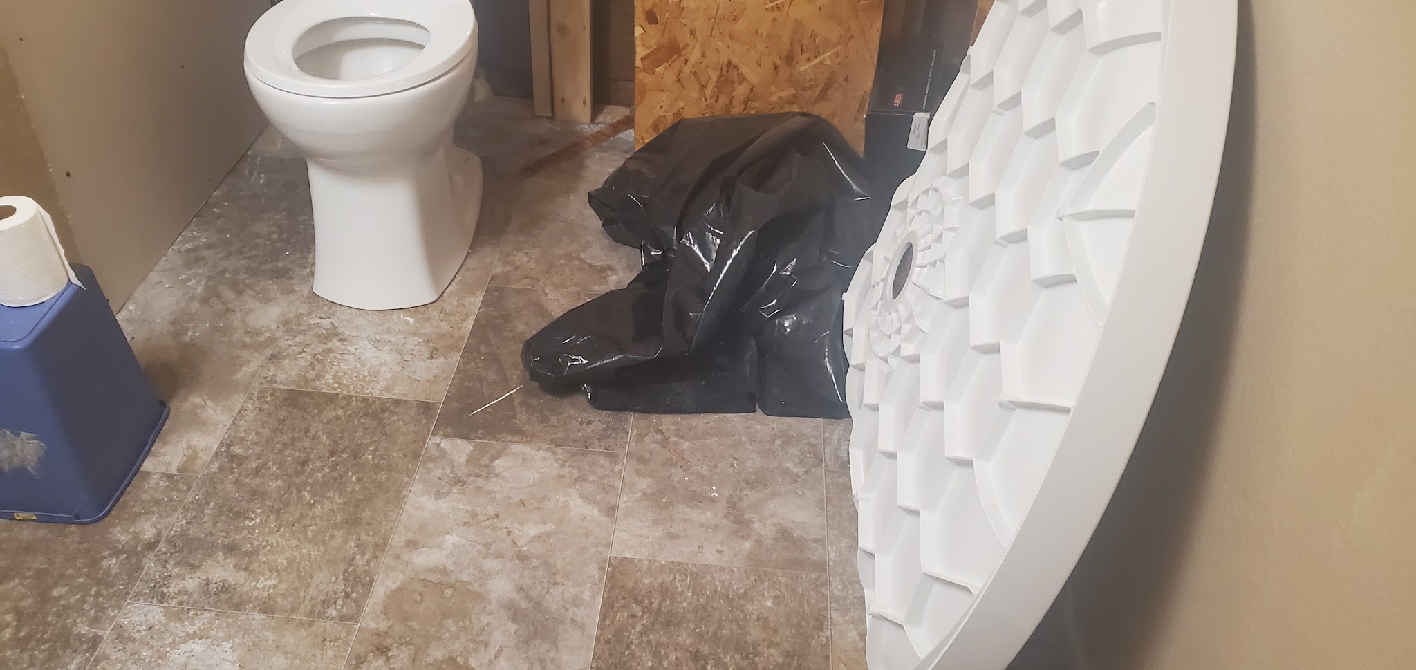 A new shower base on site, waiting to be set during a bathroom fit out